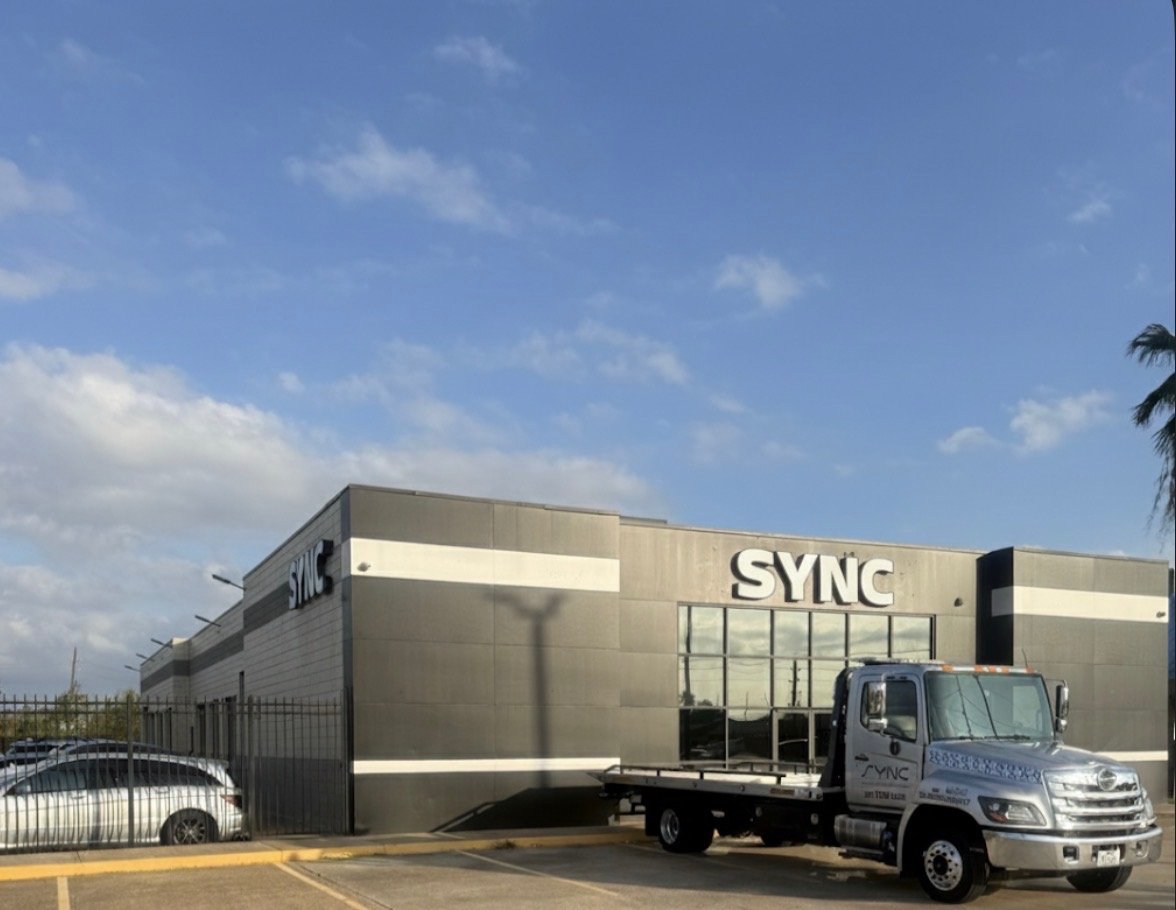 SYNC building exterior with company truck parked in parking lot